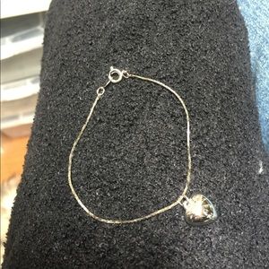 Silver bracelet with heart charm.